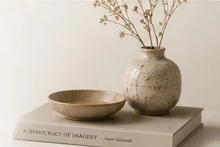Ceramic vase and bowl on stacked books